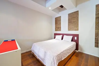 a bedroom with a bed and a red cabinet at Sunny Apartments Barcelona in Barcelona