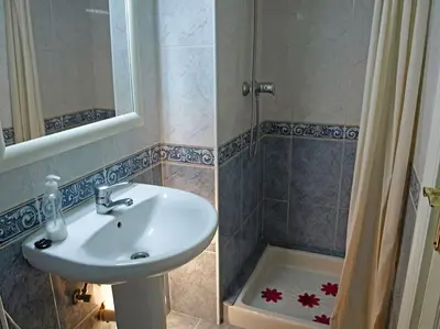 a bathroom with a sink and a shower at Apartamentospedroche Sitges in Sitges