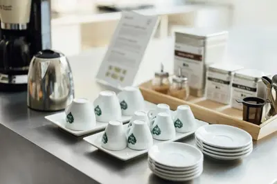 a group of white plates and cups and plates on a counter at Casa Jam Barcelona in Barcelona