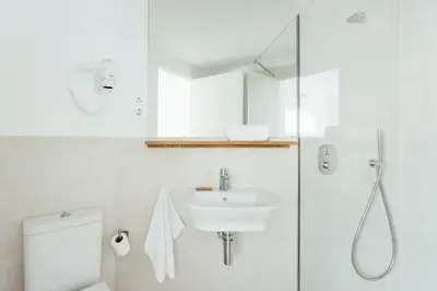 a bathroom with a toilet and a sink and a shower at Casa Jam Barcelona in Barcelona