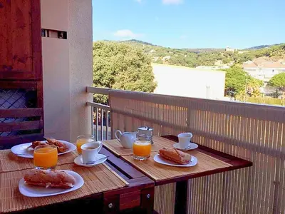a table with plates of food and glasses of orange juice at Coast apartment near Barcelona in Sant Andreu de Llavaneres
