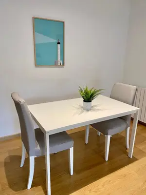 a white dining room table with two chairs and a mirror at Coast apartment near Barcelona in Sant Andreu de Llavaneres
