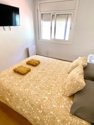 a bedroom with a bed with two towels on it at Coast apartment near Barcelona in Sant Andreu de Llavaneres