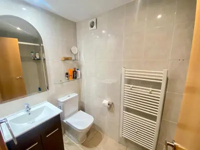 a bathroom with a white toilet and a sink at Coast apartment near Barcelona in Sant Andreu de Llavaneres