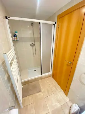 a shower with a glass door in a bathroom at Coast apartment near Barcelona in Sant Andreu de Llavaneres