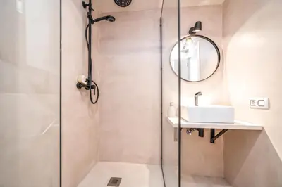 a shower stall with a sink and a mirror at GRANVIA732 in Barcelona