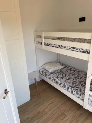 a small room with two bunk beds in it at Apartamento entre mar y montaña in Arenys de Munt