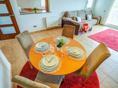 a dining room table and chairs with a table and a couch at Villa Papallona by Hello Homes Sitges in Sant Pere de Ribes