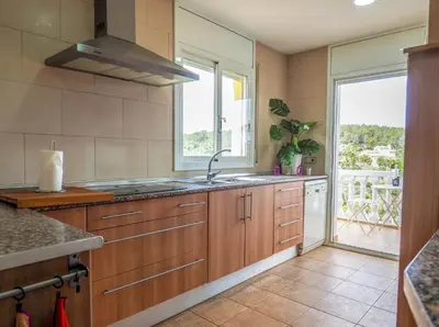 a kitchen with a sink and a large window at Villa Papallona by Hello Homes Sitges in Sant Pere de Ribes