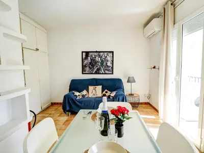 a living room with a blue couch and a table at Espalter Onyx by Hello Homes Sitges in Sitges