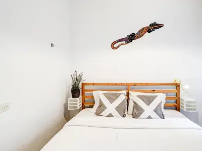 a bedroom with a bed with a gun on the wall at Espalter Onyx by Hello Homes Sitges in Sitges