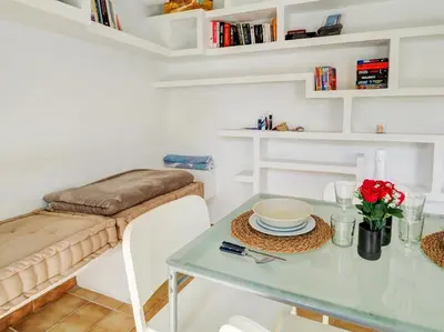 a dining room with a table and a bench at Espalter Onyx by Hello Homes Sitges in Sitges