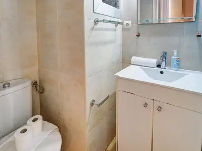a bathroom with a toilet and a sink at Espalter Onyx by Hello Homes Sitges in Sitges