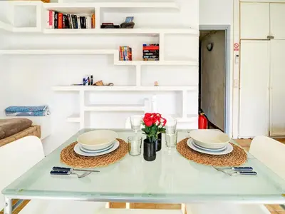 a dining room table with two plates and flowers on it at Espalter Onyx by Hello Homes Sitges in Sitges