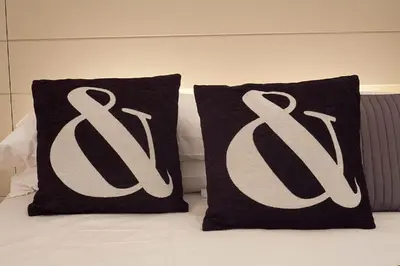 two black and white pillows on a bed at Cathedral Apartment in Barcelona
