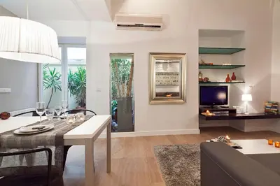 a living room with a dining table and a couch at Cathedral Apartment in Barcelona