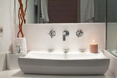 a bathroom with a sink and a candle at Cathedral Apartment in Barcelona