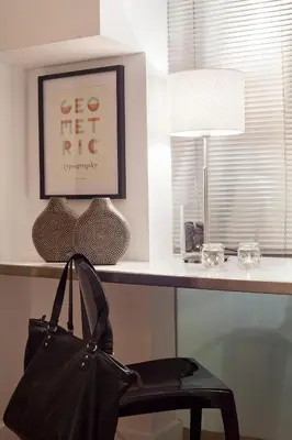 a black purse sitting on a desk with a chair at Cathedral Apartment in Barcelona