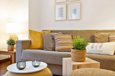 a living room with a couch and a table at Columbus Apartment in Barcelona