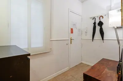a room with two umbrellas hanging on a wall at Bright 3BR2BA w Balcony in Eixample in Barcelona