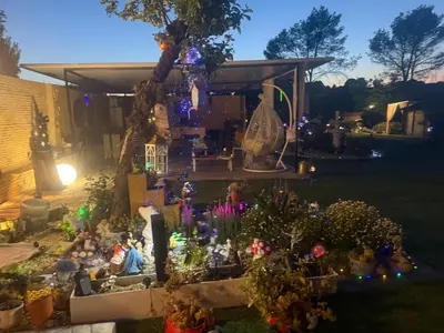 a group of people sitting in a garden at night at Casa kintsugi in Masquefa
