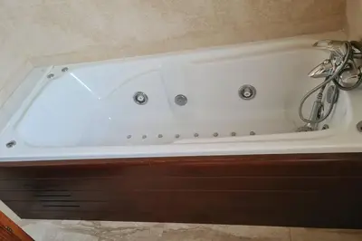 a white bath tub sitting in a bathroom at Casa rustica con piscina y jardin in Pineda de Mar
