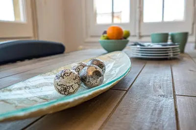 a wooden table with a plate with eggs on it at Habitat Apartments Bailén in Barcelona