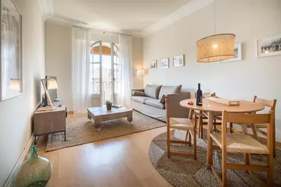 a living room with a couch and a table at Habitat Apartments Bailén in Barcelona