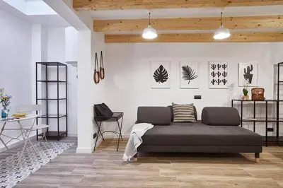 a bedroom with a bed and a table and a chair at BeBarceloner Eixample Duplex Apartments in Barcelona