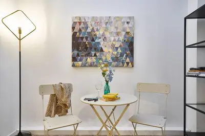 a dining room with two chairs and a table at BeBarceloner Eixample Duplex Apartments in Barcelona