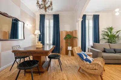 a living room with a table and chairs and a couch at Balmes Apartment by Olala Homes in Barcelona
