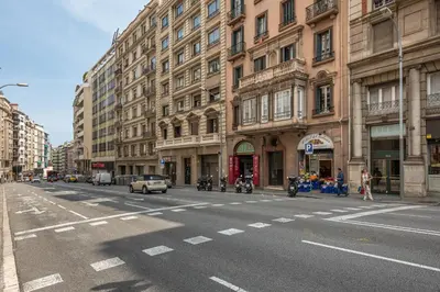 an empty city street with buildings and cars on the road at Balmes Apartment by Olala Homes in Barcelona