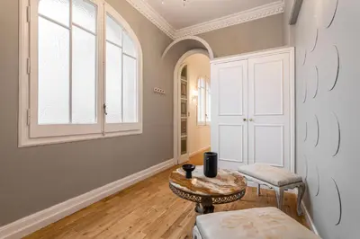 a living room with a table and a window at Balmes Apartment by Olala Homes in Barcelona