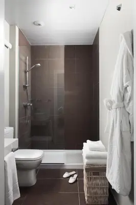 a bathroom with a shower and a toilet and a sink at Rambla 102 in Barcelona