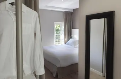 a bedroom with a white bed and a mirror at Rambla 102 in Barcelona