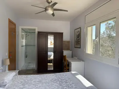a bedroom with a bed and a ceiling fan at Olivella Bed&breakfast in Olivella