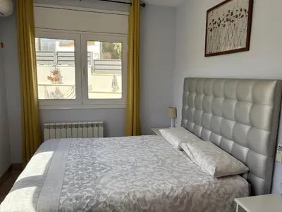 a bedroom with a bed and a window at Olivella Bed&breakfast in Olivella