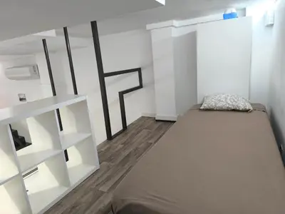a small room with a bed and a shelf at La casa del Mamut - Viladecans in Viladecáns