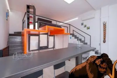 a room with a table with a cow on the floor at La casa del Mamut - Viladecans in Viladecáns