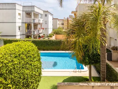 a view of a swimming pool with trees and buildings at Apartment Girona by Interhome in Cubelles