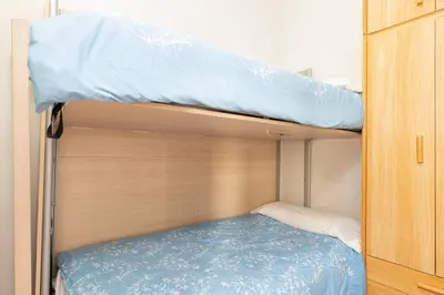 two bunk beds in a small room at ApartEasy - Modernist flat in Eixample center in Barcelona