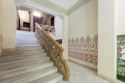 a staircase in a home with ornate stair railing at ApartEasy - Modernist flat in Eixample center in Barcelona