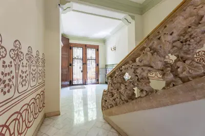 a staircase in a house with rocks on the wall at ApartEasy - Modernist flat in Eixample center in Barcelona