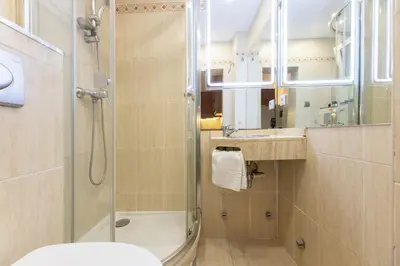 a bathroom with a shower and a toilet and a sink at ApartEasy - Central Barcelona Studio Apartment in Barcelona