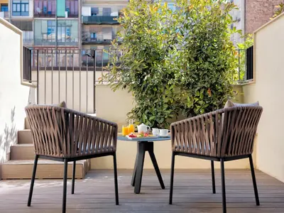 two chairs and a table with breakfast on a balcony at H10 Art Gallery 4* Sup in Barcelona