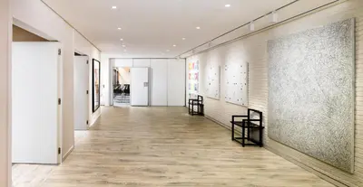 a hallway with white walls and wooden floors at H10 Art Gallery 4* Sup in Barcelona