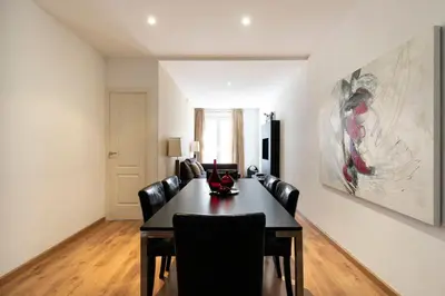 a dining room with a table and leather chairs at AB Eixample Miró Park in Barcelona