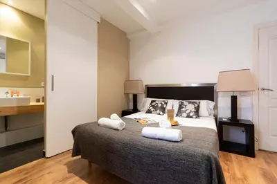 a bedroom with a bed with towels on it at AB Eixample Miró Park in Barcelona