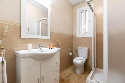 a bathroom with a sink and a toilet and a shower at AB Eixample Miró Park in Barcelona