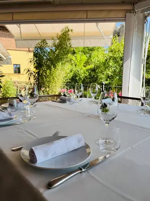a table with a napkin and a fork and knife at Hostal de la Plaça - Hotel Boutique in Cabrils